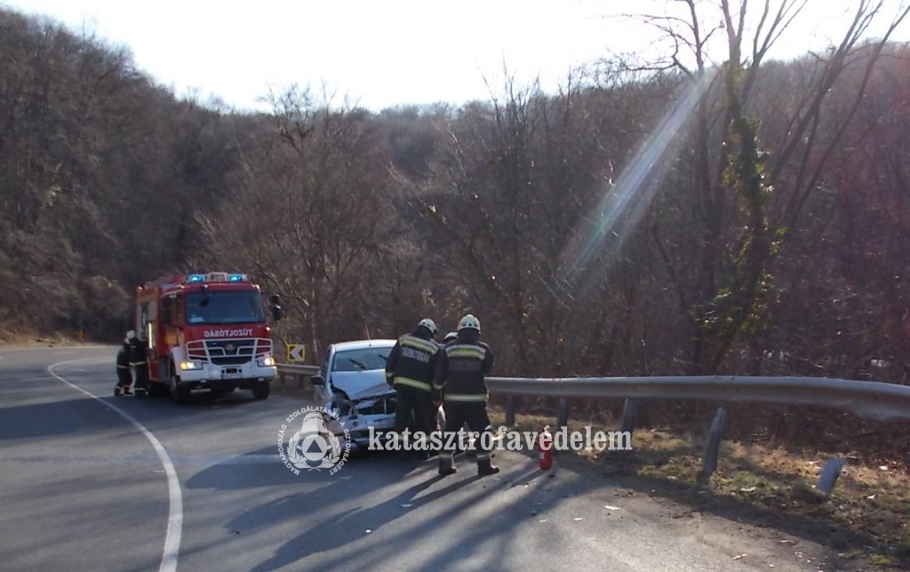 szalagkorlátnak hajtott, összetört autó, tűzoltók